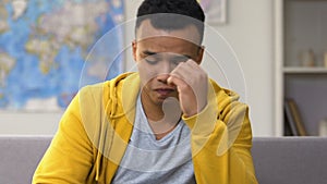 Afro-american teenager feeling upset with favorite sports team losing playoffs