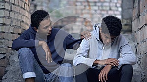 Afro-american teenager trying to make peace with friend, helping boy in need