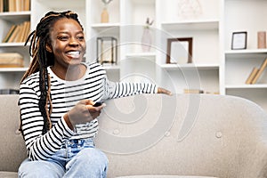 Afro American Woman Enjoying Leisure Time with Remote at Home