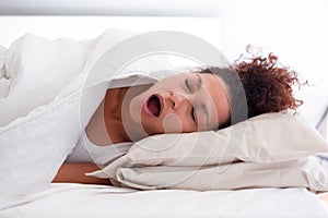 Afro american woman portrait snoring in bed