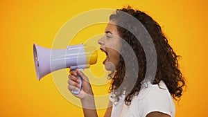 Afro-American woman shouting in megaphone, way to reliving stress, side view