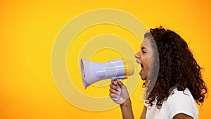 Afro-American woman shouting in megaphone, way to reliving stress, side view