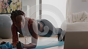 Afro american woman with sportswear stretching yoga exercises on fitness map