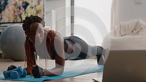 Afro american woman with sportswear stretching yoga exercises on fitness map