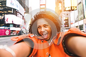 Afro american woman taking selfie in Time square, New york