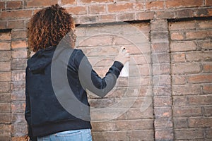 Afro-american woman using spray paint