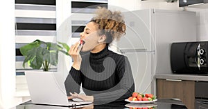 Afro american woman wearing headphones studying online