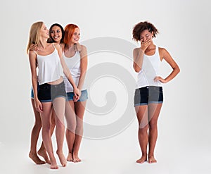 Afro american women standing while friends laughing with her