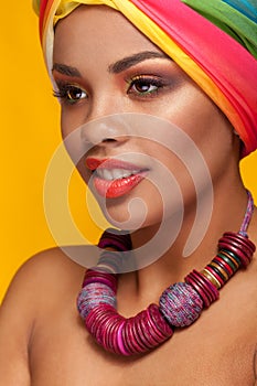 Afro american young woman wearing a turban and necklace