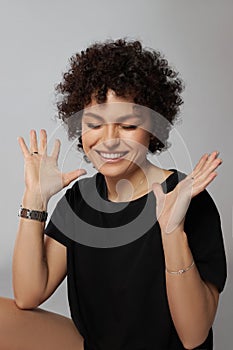 Afro curly hair fashion woman, natural makeup and cosmetics. Beauty face smile portrait of a woman with black curly hair, afro