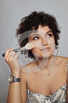 Afro curly hair fashion woman, natural makeup and cosmetics. Beauty face smile portrait of a woman with black curly hair, afro