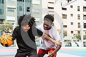 Afro friends playing basketball outdoor