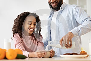 Afro Girl And Her Handsome Dad Pouring Milk In Cereal