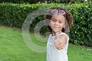 afro girl standing in the park. Casual style