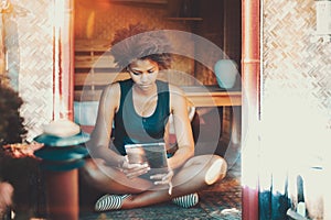 Afro girl on summer veranda with tablet pc