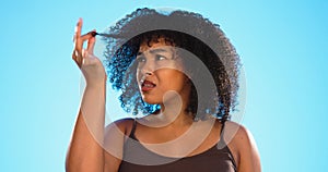 Afro, hair damage and confused black woman on blue background with problem, hairstyle frizz and loss. Beauty salon