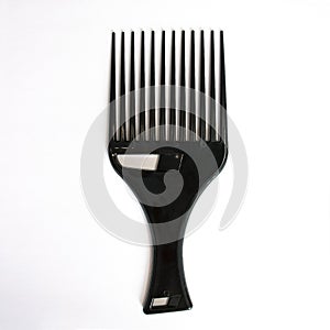 Afro Hair Pick, AfroPick a comb for curly hair on isolated white background.
