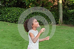 Afro-haired girl playing in the park