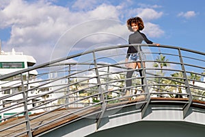 Afro hairstyle woman on roller skates riding outdoors on urban b