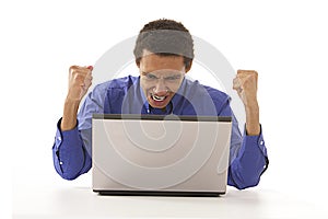 Afro man angrily shouting at his laptop