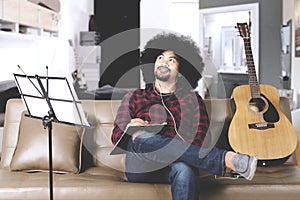 Afro man composing song at home photo