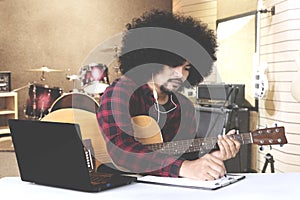 Afro man composing song in music studio photo