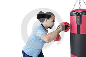 Afro man punching a boxing sack