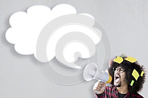Afro man shouting at empty speech bubble