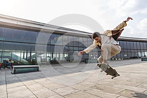 Afro man skateboarder flies in air on skateboard