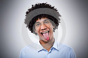 Afro man sticking tongue out