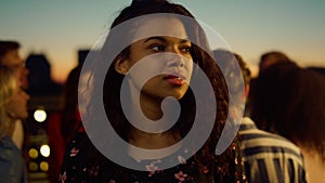 Afro model looking camera at party. Portrait african woman smiling outdoors.