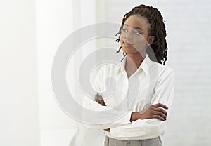 Afro Office Girl Crossing Hands Standing Next To White Wall