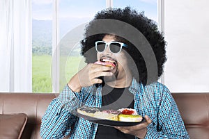 Afro person eating donuts