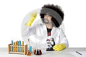 Afro scientist looking at a microscope slide