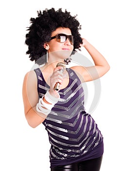 Afro singer holding microphone over white