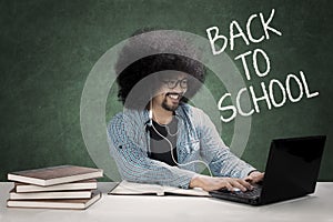 Afro student using a laptop and headset