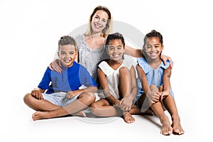 Afro twin child and boy posing on a white background studio with white mother