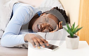 Afro Woman Touching Head Suffering From Headache Lying In Bed