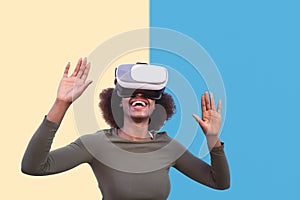 Afro woman using virtual reality glasses outdoor - Happy young girl having fun with innovated vr googles technology photo