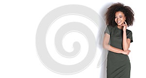 Afroamercian young woman in dark green dress on white background.