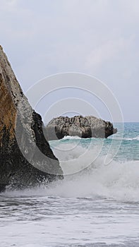Afrodite rock formation, ocean with weaves, coast Cyprus photo