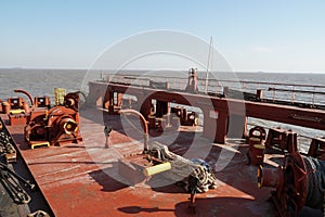 Aft stern mooring maneuvering station of cargo container vessel with winches, bollards, ropes. Ship is without containers.