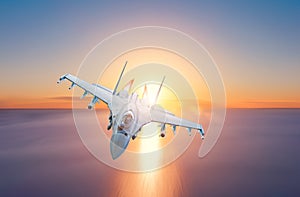 Afterburner fighter jet flies over the sea during sunset photo