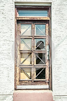 Aftermath demolished window of abandoned ruined house destroyed by earthquake or hurricane vertical image