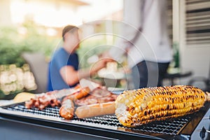 Afternoon Party Group friends enjoying drinking beer with barbecue and roast pork happy while enjoying home party