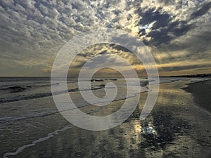 Afternoon sunlight on beach waves photo