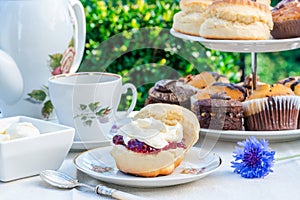 Afternoon tea with cakes and traditional English scones photo