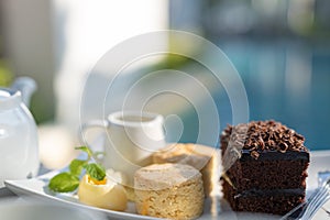 Afternoon tea set with hot tea, chocolate brownie