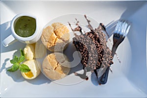 Afternoon tea set with hot tea, chocolate brownie