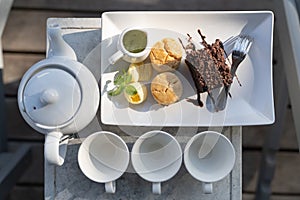 Afternoon tea set with hot tea, chocolate brownie